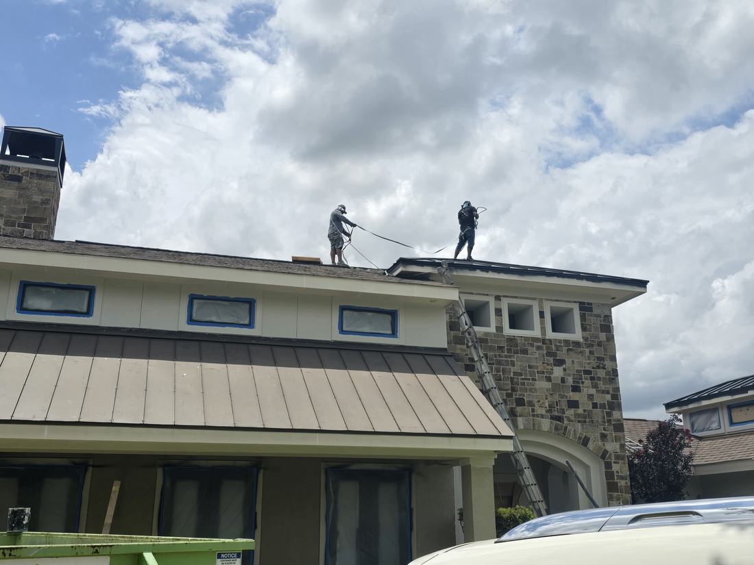 Off The Wall crew soft-washing a residential roof