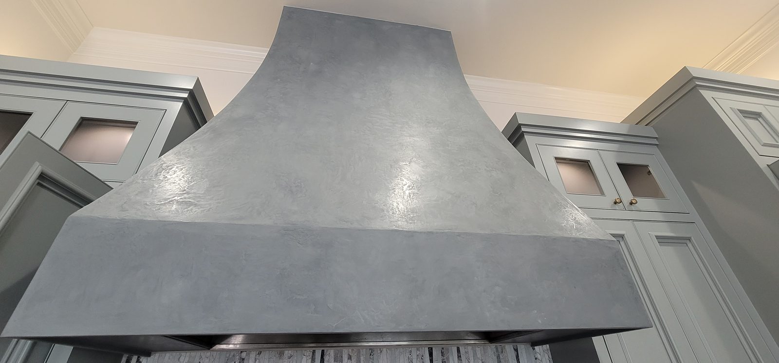 Smooth polished plaster finish on a custom range hood