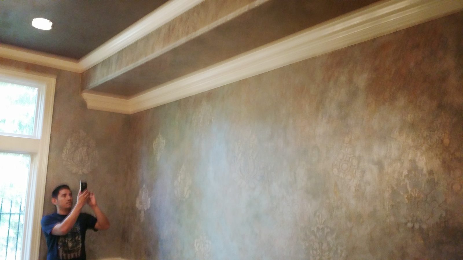 Decorative faux finish being applied to an interior wall
