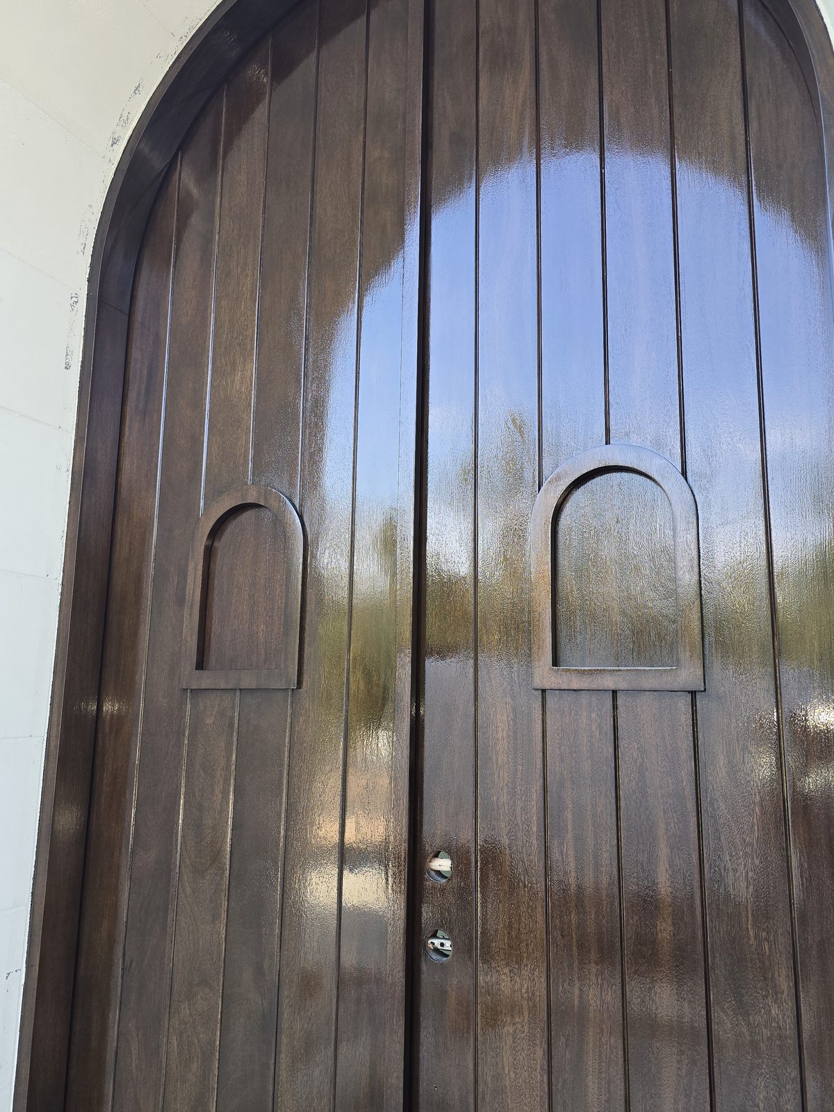 High-gloss lacquer finish on a stained timber door