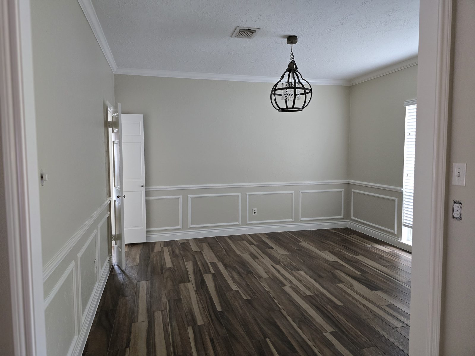 Completed painted trim and wainscoting in a residential room
